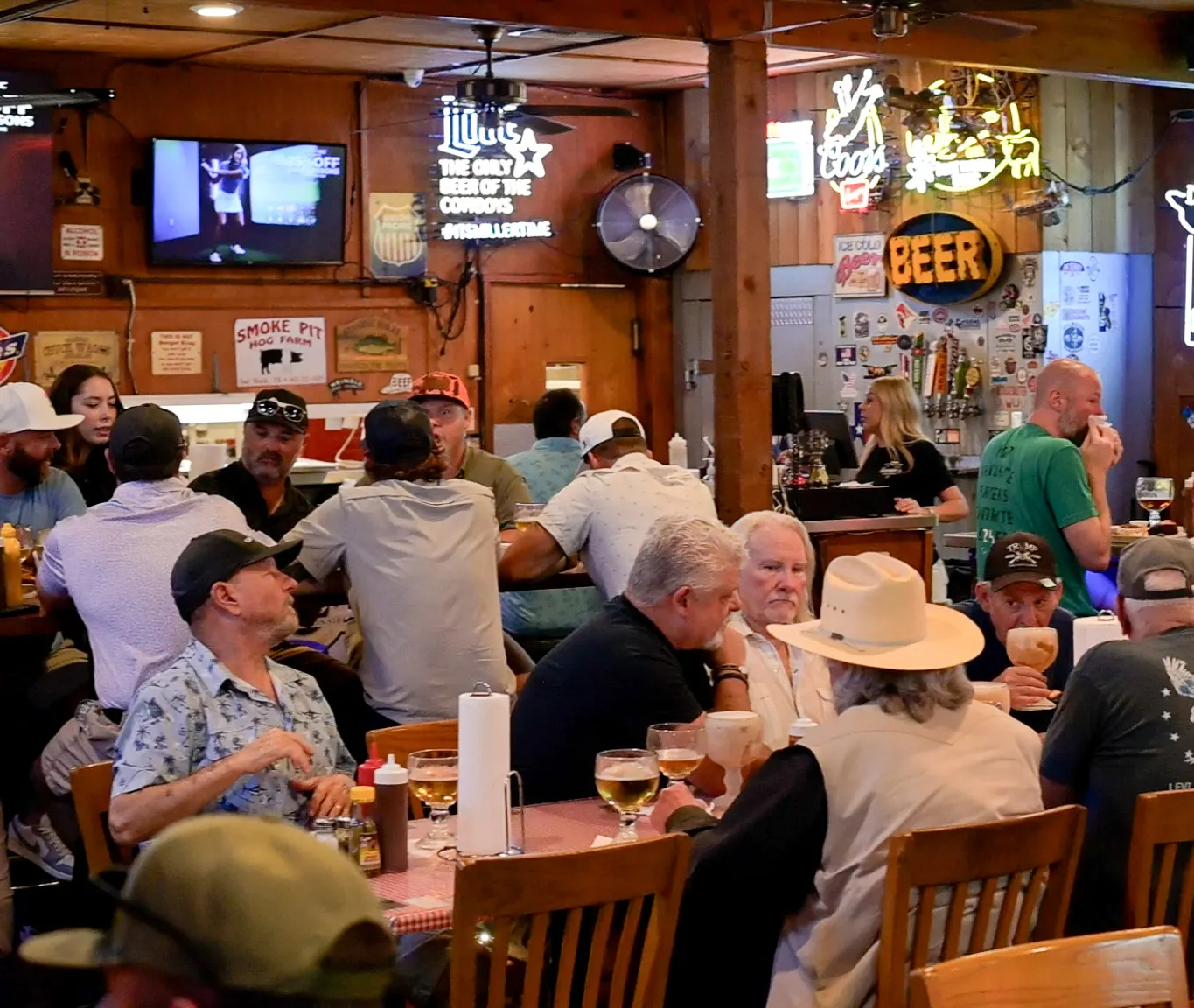A packed dining room at Sammie's, every table full under the neon