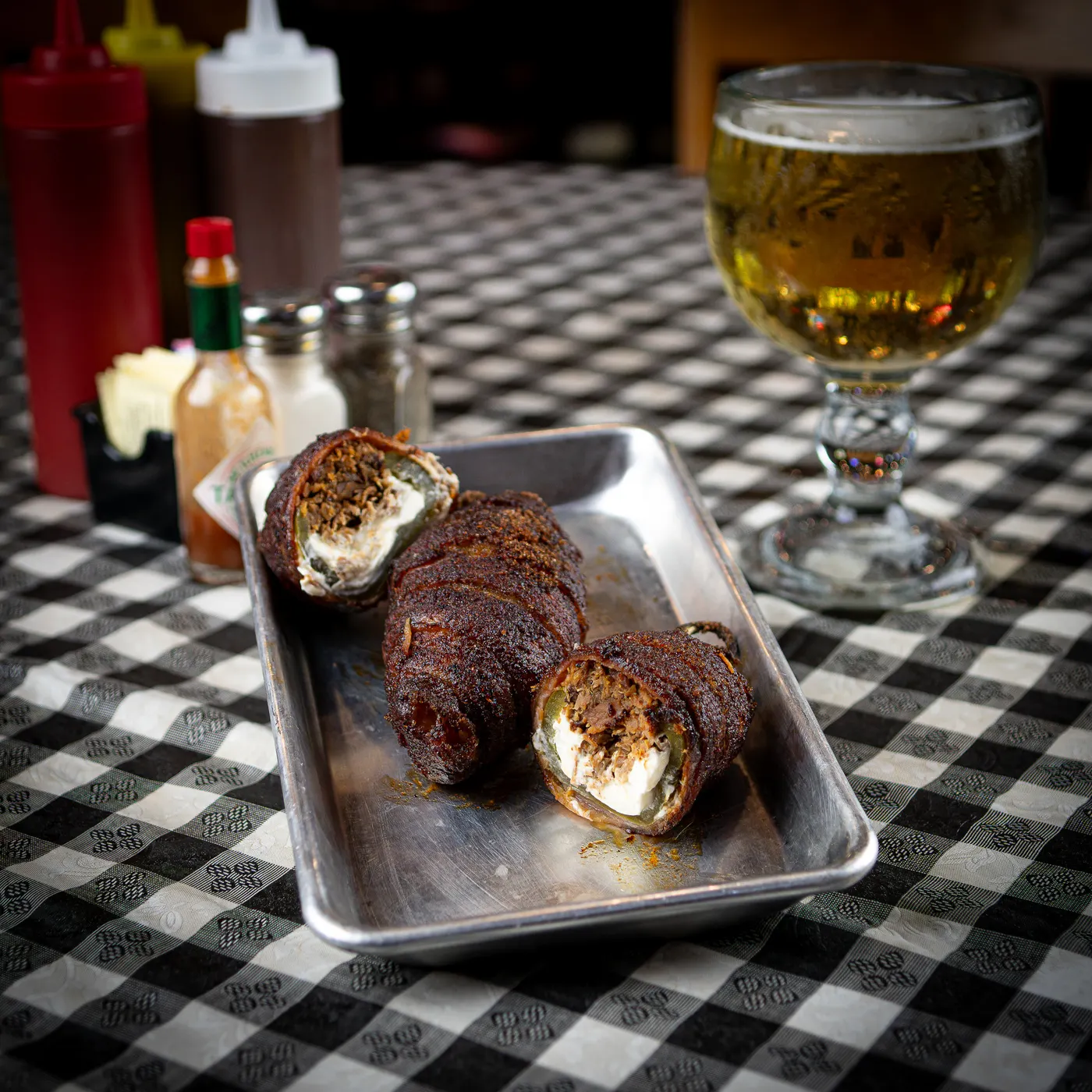 Bacon-wrapped Texas Twinkies stuffed with brisket and cream cheese on a tray