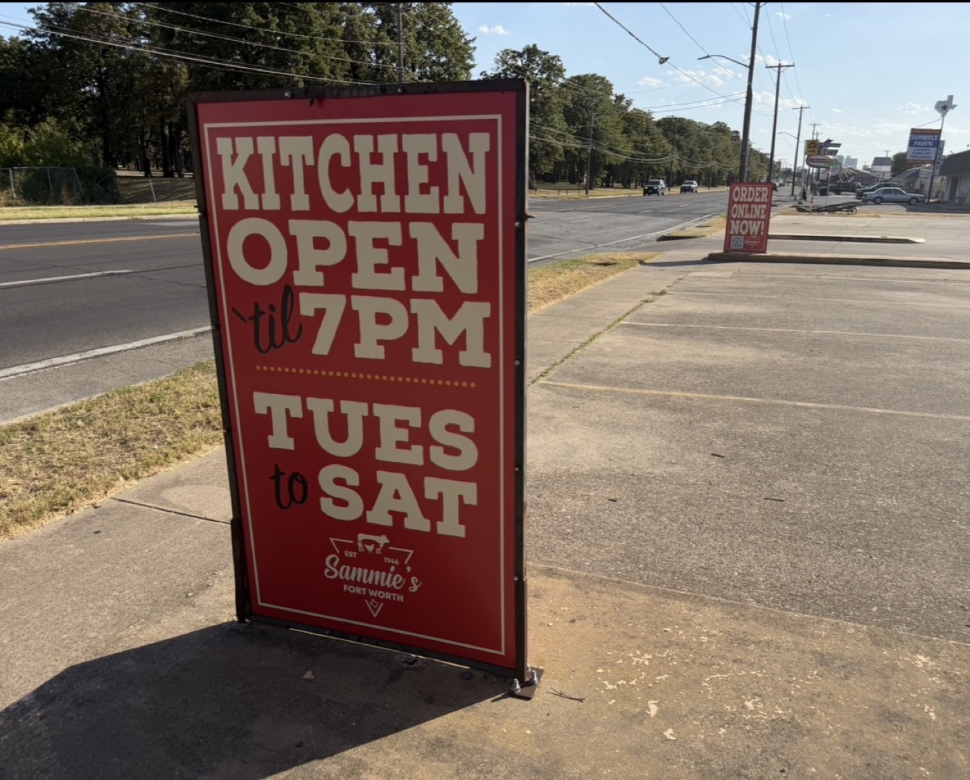 Kitchen open til 7 PM Tuesday to Saturday sandwich board on the sidewalk