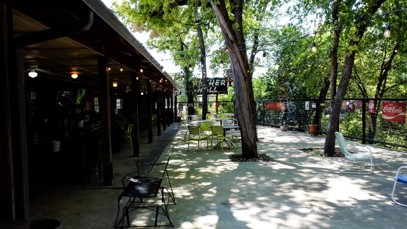 The covered patio at Sammie's, shaded tables under the trees
