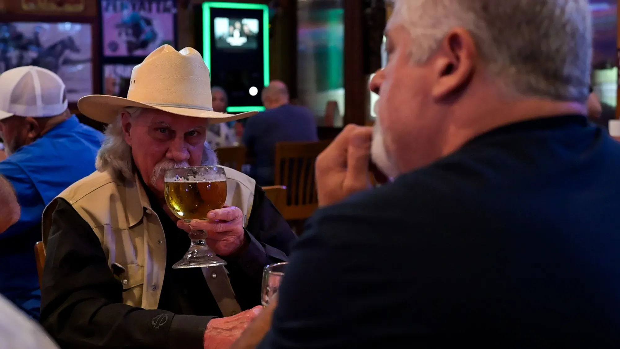 A guest in a cowboy hat with a cold beer at Sammie's