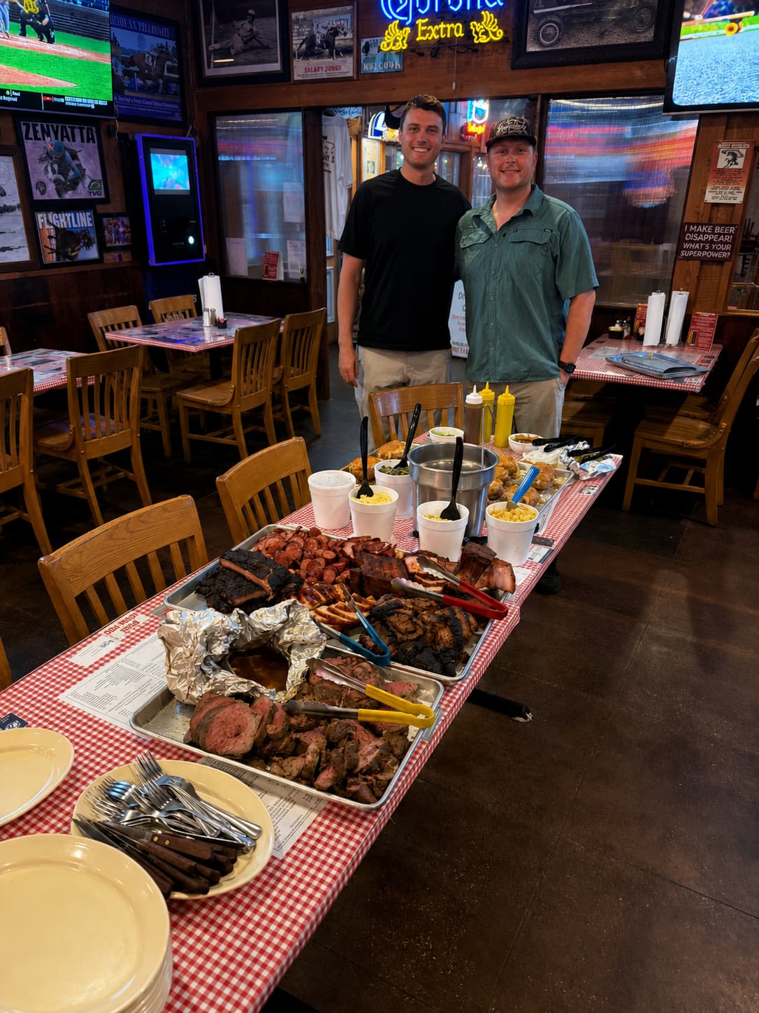 Owner and pitmaster Sammy Gibbins with a spread of smoked meats at Sammies BBQ