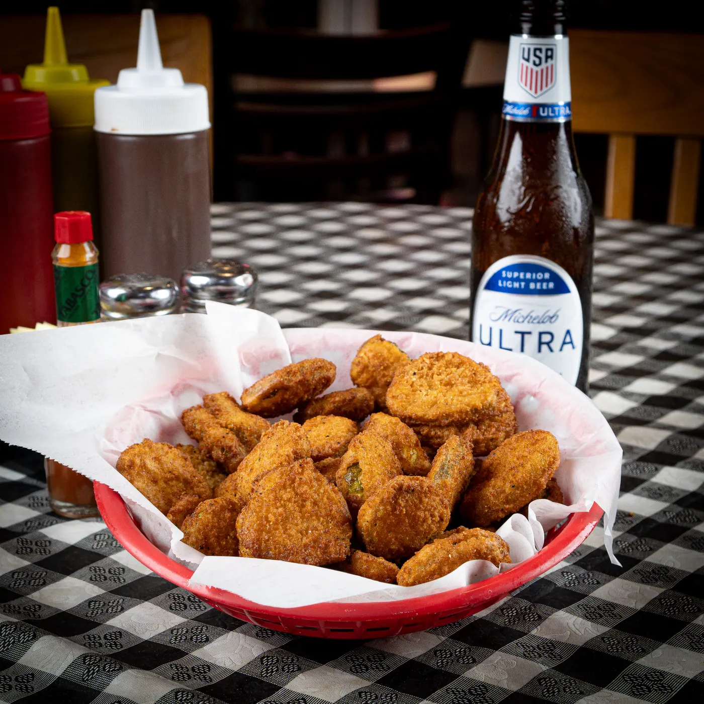 A basket of golden fried pickle spears