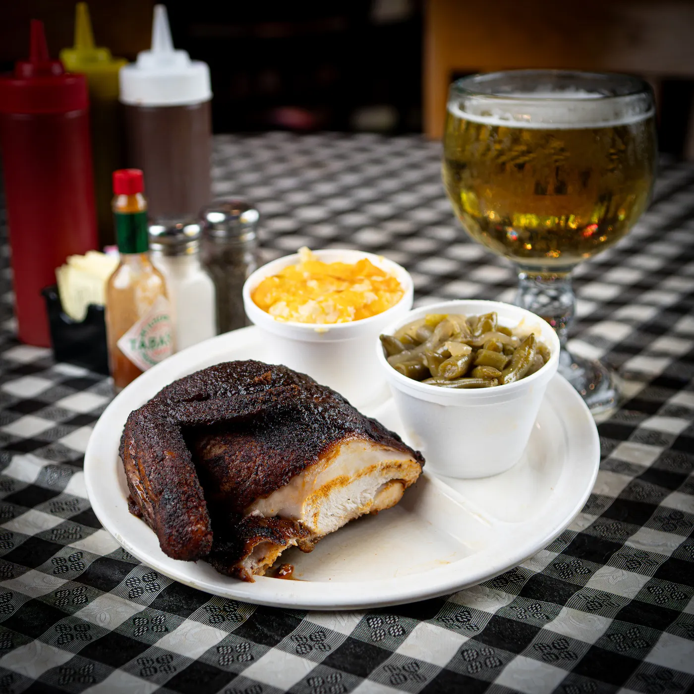 Half a smoked chicken with onion rings and fried okra