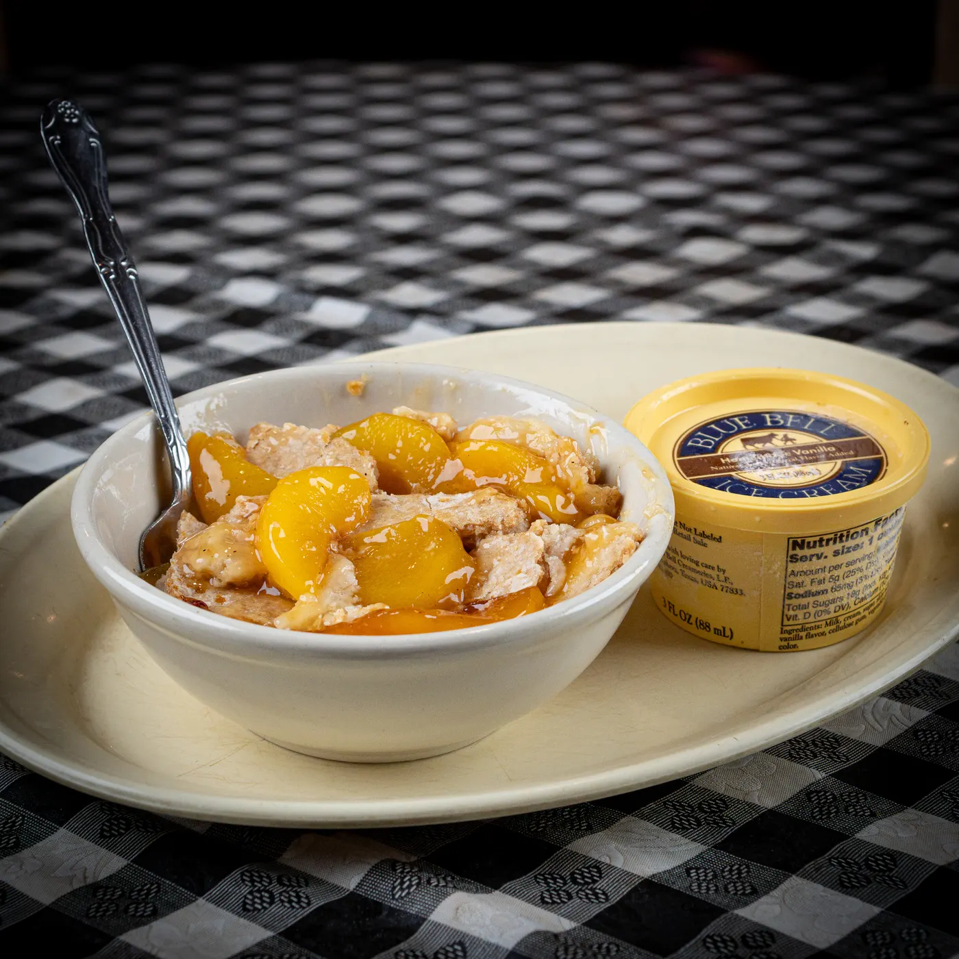 Peach cobbler with a scoop of Bluebell ice cream
