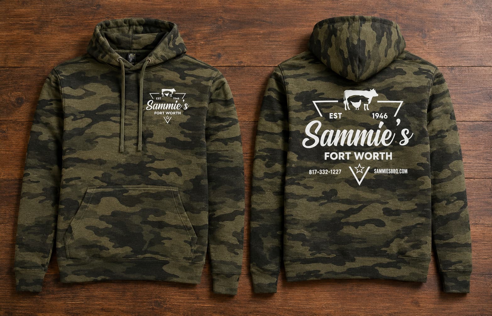 Camo Sammie's hoodie, front and back, on a wood table