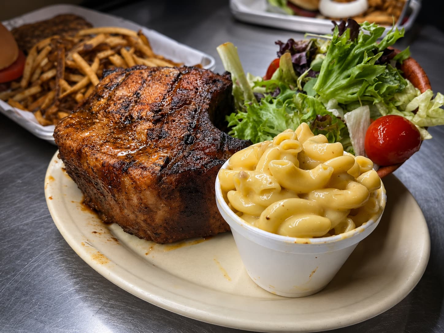 Smoked pork chop plate with mac and cheese and salad